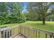 Expansive backyard featuring a deck with wooded views and mature trees offering shade at 170 White Rose Ln, Temple, GA 30179