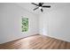 This bedroom features wood floors, neutral walls, and a window view at 170 White Rose Ln, Temple, GA 30179