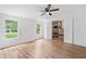 Bedroom featuring laminate floors, two windows, and a door to the bathroom at 170 White Rose Ln, Temple, GA 30179