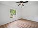 This bedroom features wood floors, a ceiling fan, and a window view at 170 White Rose Ln, Temple, GA 30179