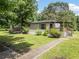 Inviting home with a covered porch, lush lawn, and mature trees, offering a serene and welcoming curb appeal at 170 White Rose Ln, Temple, GA 30179