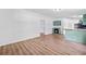 Open kitchen with green cabinets, breakfast bar, and wood floors at 170 White Rose Ln, Temple, GA 30179