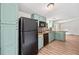 View of kitchen features a kitchen island, cabinets, and black appliances at 170 White Rose Ln, Temple, GA 30179
