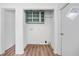 Laundry room featuring built in shelving and wood-look floors at 170 White Rose Ln, Temple, GA 30179