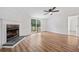 Living room featuring laminate floors, a fireplace, sliding glass doors to the backyard, and neutral paint at 170 White Rose Ln, Temple, GA 30179