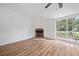 Bright living room features a fireplace, wood floors, and sliding glass doors to the outdoor deck at 170 White Rose Ln, Temple, GA 30179
