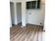 A small room with light wood flooring, white walls and trim, and a small cabinet at 170 White Rose Ln, Temple, GA 30179