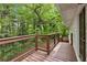 The property includes a back deck overlooking a serene backyard with lush greenery and privacy at 2488 Fontainebleau Dr, Dunwoody, GA 30360