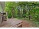Wooden back deck extending into a lush, wooded area providing a natural outdoor space at 2488 Fontainebleau Dr, Dunwoody, GA 30360