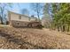 Backyard view showcasing the home's exterior, deck, and wooded surroundings at 2488 Fontainebleau Dr, Dunwoody, GA 30360