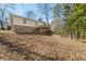 Backyard with deck and stairs, surrounded by mature trees and natural foliage at 2488 Fontainebleau Dr, Dunwoody, GA 30360