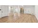 Large open basement space features wood-look flooring, bright lighting, and multiple access doors to other areas at 2488 Fontainebleau Dr, Dunwoody, GA 30360