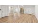 Finished basement featuring wood-look flooring, white support columns, and access to storage areas at 2488 Fontainebleau Dr, Dunwoody, GA 30360