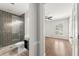 Bathroom view, featuring glass door shower, toilet, and view into bright bedroom at 2488 Fontainebleau Dr, Dunwoody, GA 30360