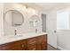 Updated bathroom features double sink vanity, modern lighting, mirrors and marble countertops at 2488 Fontainebleau Dr, Dunwoody, GA 30360