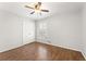 Bright bedroom features hardwood floors, ceiling fan and natural light from the window at 2488 Fontainebleau Dr, Dunwoody, GA 30360