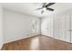 Bedroom featuring wood floors, ceiling fan, a window with shutters and a closet at 2488 Fontainebleau Dr, Dunwoody, GA 30360