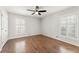 Spacious bedroom with hardwood floors, neutral walls, and window with shutter-style blinds at 2488 Fontainebleau Dr, Dunwoody, GA 30360