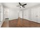 Bedroom features wood floors, ceiling fan, and multiple closets at 2488 Fontainebleau Dr, Dunwoody, GA 30360