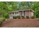 Brick and white-sided house with well-maintained landscaping and an attached garage at 2488 Fontainebleau Dr, Dunwoody, GA 30360