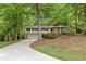 Charming split-level home with a two-car garage and long driveway, nestled among mature trees at 2488 Fontainebleau Dr, Dunwoody, GA 30360