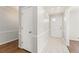 Hallway featuring gray walls, white trim, tile flooring near front door and access to wood flooring at 2488 Fontainebleau Dr, Dunwoody, GA 30360