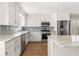 This kitchen has stainless steel appliances, granite countertops, gray backsplash and white cabinets at 2488 Fontainebleau Dr, Dunwoody, GA 30360