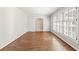 Clean, empty living room with wood flooring and a large window, ready for new memories at 2488 Fontainebleau Dr, Dunwoody, GA 30360