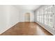 Bright and open living room with hardwood floors, neutral walls, and large windows with shutter blinds at 2488 Fontainebleau Dr, Dunwoody, GA 30360