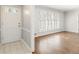 Bright living room with hardwood floors, white trim, a front door and large window at 2488 Fontainebleau Dr, Dunwoody, GA 30360