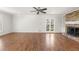 Open-concept living room featuring a fireplace and access to an outdoor deck at 2488 Fontainebleau Dr, Dunwoody, GA 30360