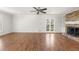 Large living room features fireplace, built-in shelves, and French doors at 2488 Fontainebleau Dr, Dunwoody, GA 30360