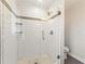 Bathroom shower with white tile, glass door, and sleek fixtures at 2488 Fontainebleau Dr, Dunwoody, GA 30360