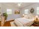Serene bedroom with hardwood floors, a comfortable bed, and ample natural light at 5702 Forest Dr, Acworth, GA 30102