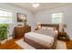 Well-lit bedroom with hardwood floors, a comfortable bed, and plenty of natural light at 5702 Forest Dr, Acworth, GA 30102