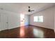 Bright bedroom featuring hardwood floors, a ceiling fan, and a large window at 1287 Peninsula Trce, Lawrenceville, GA 30044
