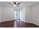 Cozy bedroom featuring a ceiling fan, window, and hardwood floors at 1287 Peninsula Trce, Lawrenceville, GA 30044