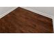 Close-up of hardwood flooring with white trim at 1287 Peninsula Trce, Lawrenceville, GA 30044