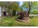 Well-maintained front yard with garden bed and mature trees at 1287 Peninsula Trce, Lawrenceville, GA 30044