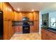 Spacious kitchen featuring black appliances, granite countertops, and abundant cabinet space at 1287 Peninsula Trce, Lawrenceville, GA 30044