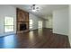 Spacious living room featuring a stone fireplace, large windows, and modern flooring at 1287 Peninsula Trce, Lawrenceville, GA 30044