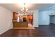 Open concept living room and kitchen featuring modern lighting and sleek flooring at 1287 Peninsula Trce, Lawrenceville, GA 30044