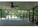Spacious sunroom with ceiling fan and ample light, perfect for relaxation and enjoying the outdoor scenery at 1287 Peninsula Trce, Lawrenceville, GA 30044