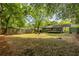 This expansive backyard features a privacy fence, mature trees, and a delightful fire pit area with backyard shed at 1875 Fairway Ne Cir, Atlanta, GA 30319