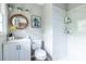 Charming bathroom features a modern vanity, a round mirror, a tiled shower, and stylish fixtures, creating a spa-like experience at 1875 Fairway Ne Cir, Atlanta, GA 30319