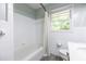 Bright bathroom boasts a well-maintained tub and shower, a functional toilet, and neutral decor, creating a tidy and efficient space at 1875 Fairway Ne Cir, Atlanta, GA 30319