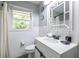 Bright bathroom with white tile, window, and modern vanity at 1875 Fairway Ne Cir, Atlanta, GA 30319