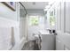 Clean bathroom features a tub with shower, a modern vanity, and fresh white tiles, offering a serene and functional space at 1875 Fairway Ne Cir, Atlanta, GA 30319