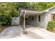 Attached carport with a gated entryway offers covered parking and leads to the home's entrance with a storage shed at 1875 Fairway Ne Cir, Atlanta, GA 30319