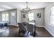 Bright dining room with modern light fixture, elegant decor, and dark hardwood floors at 1875 Fairway Ne Cir, Atlanta, GA 30319